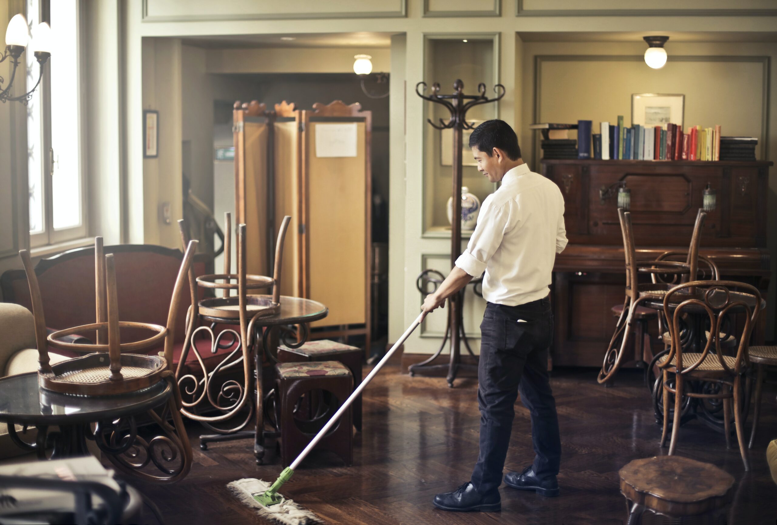 Employee of Ontario Cleaning Supply and Services happily cleaning